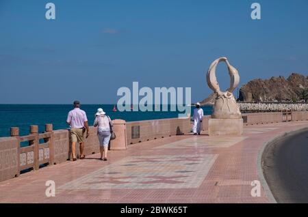 Touristen zu Fuß auf der Mutrah Corniche, Muscat, Sultanat von Oman. Stockfoto