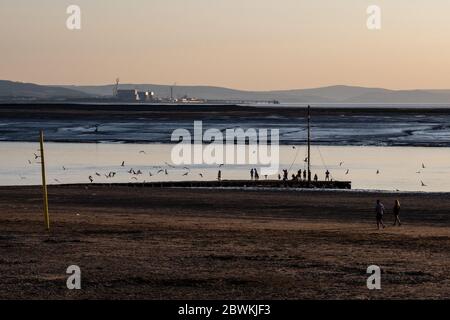 Burnham-on-Sea, England, Großbritannien - 31. Mai 2020: Menschen fischen, spazieren, joggen und spielen am Strand und in den Schlammwohnungen an der Mündung des Flusses Parrett in Burnham-on Stockfoto