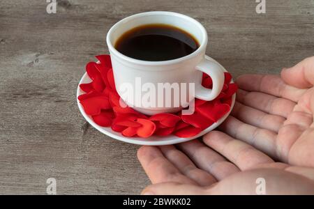 Tasse duftenden Kaffee. Tasse und Herren Hände. Romantisches Thema, Kaffee mit Liebe.. Stockfoto