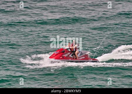 Frau und Kind fahren ein persönliches Wasserfahrzeug (PWC), auch als Wasserroller, auf Canyon Lake, künstliche Reservoir in Hill Country, Texas, USA Stockfoto