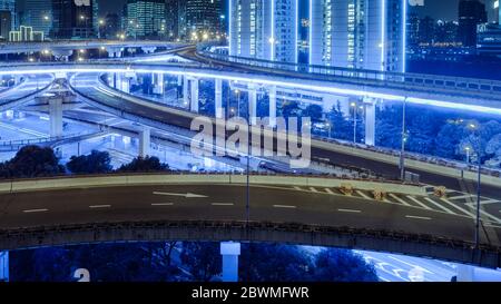 Luftaufnahme von Gebäuden und Verkehr mehrstufige Kreuzung bei Nacht in Shanghai Stadt Stockfoto
