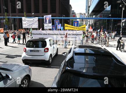 02. Juni 2020, Hessen, Frankfurt/Main: Mit Bannern in den Händen, unter anderem mit der Aufschrift "Letzte Wendemöglichkeit #Keine GeldfeldfürGestern", "Taatshilfen ohne Klimaschutz führen in die Sackgasse", blockieren Demonstranten den Stoßverkehr auf der Neuen Mainzer Straße im Frankfurter Bankenviertel. Mehrere Initiativen und Umweltgruppen haben sich gegen die Prämien für den Autokauf und für eine Verkehrswende auf die Straße gemacht. Foto: Arne Dedert/dpa Stockfoto