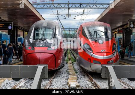 Italienischer Hochgeschwindigkeitszug - zwei rote Hochgeschwindigkeitszüge, Alstom Pendolino von NTV und Frecciarossa 1000 von Trenitalia, bei Rom Termini, Italien. Stockfoto