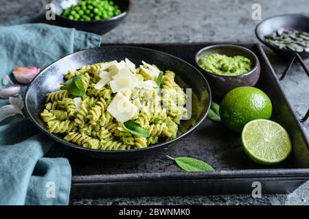 Fusilli Pasta mit Pesto aus Salbei und Kürbiskernen mit Hartkäse gekrönt Stockfoto