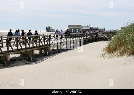 St. Peter Ording, Deutschland. Juni 2020. Urlauber sind auf der Anlegestelle in Sankt Peter-Ording. Der Pier verbindet einen Strandabschnitt mit der Promenade und ist gut einen Kilometer lang. St. Peter-Ording wurde wegen der Koronakrise über Pfingsten einem Verbot von Tagesbesuchern ausgesetzt. Kredit: Bodo Marks/dpa/Alamy Live News Stockfoto