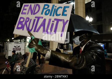 Portland, USA. Juni 2020. Die Regenschirm-Mann-Statue auf dem Pioneer Square hält ein Schild an der fünften Nacht der Aktion gegen Polizeibrutalität in Portland, Oregon, am 2. Juni 2020, nach dem Tod von George Floyd in Polizeigewahrsam. (Foto: Alex Milan Tracy/Sipa USA) Quelle: SIPA USA/Alamy Live News Stockfoto