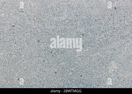 Hellgraue Asphaltstruktur im Sommer Stockfoto