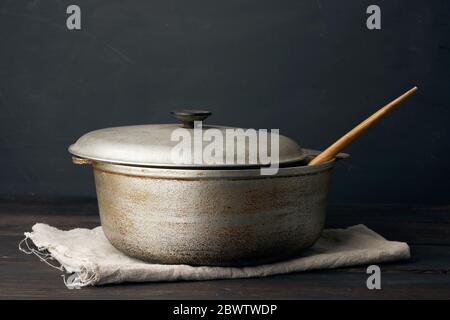 Aluminium alten Kessel auf einem Holztisch, Küchenutensilien, aus der Nähe Stockfoto