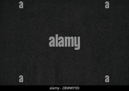 Schwarzer Sand Wand Textur Hintergrund. Stockfoto