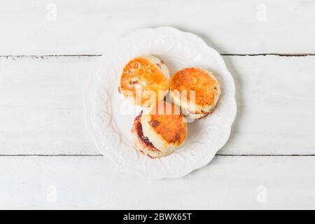 Scones, Scones mit Marmelade und Tee mit Milch Nahaufnahme auf dem Tisch Stockfoto