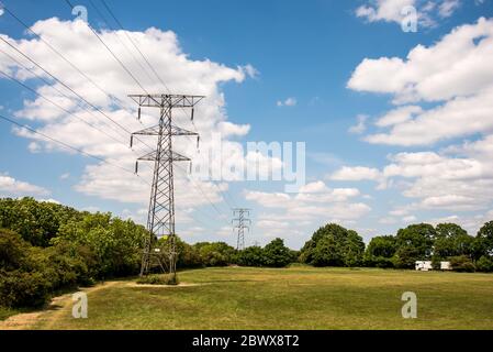 Hochspannungsleitungen auf der linken Seite des Feldes. Hochspannungsleiter Hochspannungsturm Stockfoto