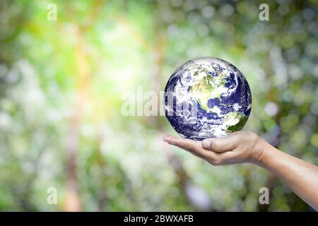 Hand hält Erde mit abstrakten grünen Blättern Bokeh und Sonnenlicht Strahl Hintergrund, geeignet für die Rettung Welt und Umwelt Konzept. Elemente von diesem Stockfoto