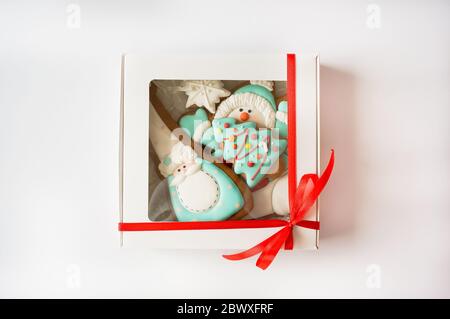 Ingwer Zucker glasierte Cookies Weihnachten niedliche Dekoration in weißen Karton rote Spitze weißen Hintergrund Stockfoto