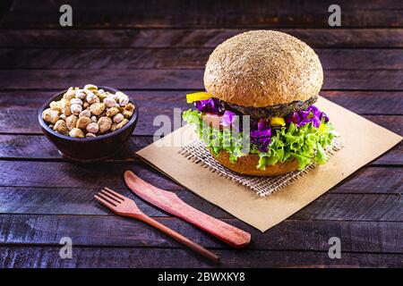 Vegetarischer Hamburger, geröstet und verzehrfertig. Gesundes und vegetarisches Lebenskonzept. fleischloser Snack auf Basis von Soja und Kichererbsen mit Holzcu Stockfoto