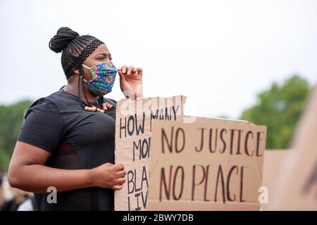 Frau, die eine Gesichtsmaske trägt, hält ein selbstgemachtes Schild auf dem protestmarsch von Black Lives Matter in Großbritannien. Hyde Park, London, England, Großbritannien Stockfoto