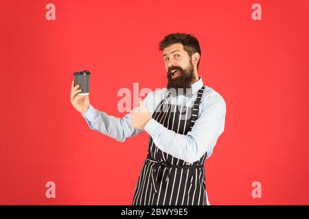 Am besten nehmen Sie Kaffee. Kaffee zu gehen. Bartender mit Pappbecher. Guten Morgen Kaffee. Frische energetische Getränk. Koch Mann empfehlen Getränk. Reife qualifizierte Barista in Schürze. Was für ein toller Morgen. Stockfoto