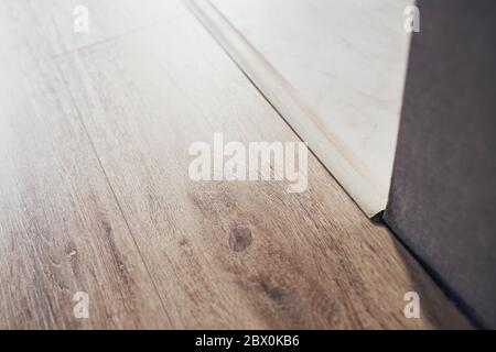 Fugen aus Laminat und Fliesen - Bodenverbinder - Zierleiste oder Schweller Stockfoto