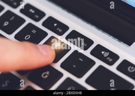 Nahaufnahme des Mannes Finger Berühren der Buchstaben Fragezeichen-Taste auf der schwarzen Computer-Tastatur Stockfoto