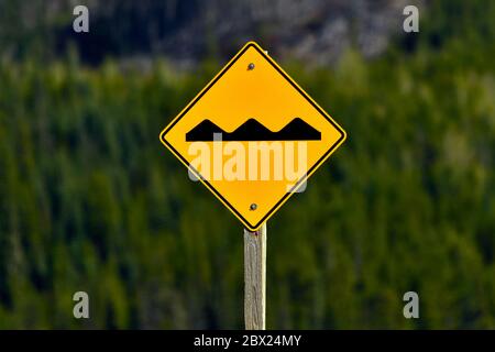 Ein Bump-Schild auf der Straße warnt den Autofahrer, dass es eine Bump auf der entgegenkommenden Straße Stockfoto