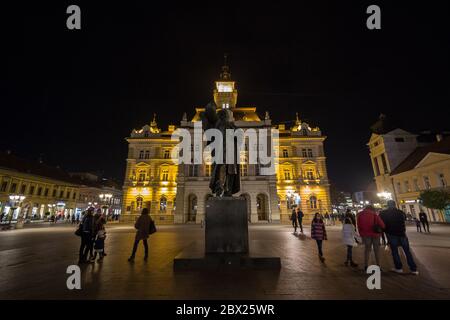 NOVI SAD, SERBIEN - 26. NOVEMBER 2016: Svetozar Miletic Statue auf Trg Slobode Platz mit dem Rathaus, oder Gradska Kuca, im Hintergrund in novi Sad, se Stockfoto