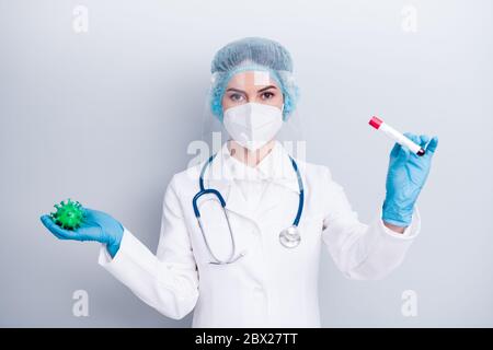 Foto von schönen Dame doc halten covid Bakterien Blut Sonde Rohr Analyse infizierenden Prozess Impfstoff Forschung tragen Handschuhe Maske Mantel Gesichts Kunststoff