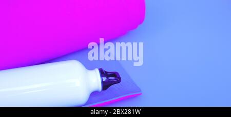 Leuchtend lila Yogamatte und eine Flasche Wasser. Stockfoto