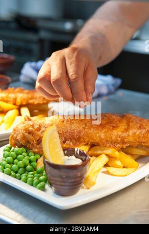 Fisch und Chips in der kommerziellen Küche in Großbritannien zubereitet Stockfoto