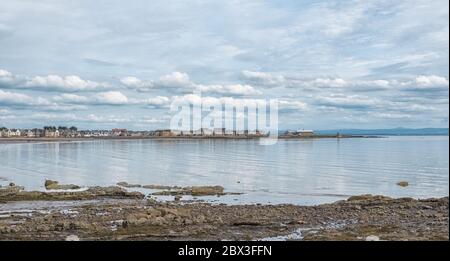 Blick über Saltcoats Bay bei Flut mit einem bewölkten, aber dramatischen Himmel. Saltcoats Pier mit seiner distiktiven runden Struktur ist auf der weit entfernten Rig zu sehen Stockfoto