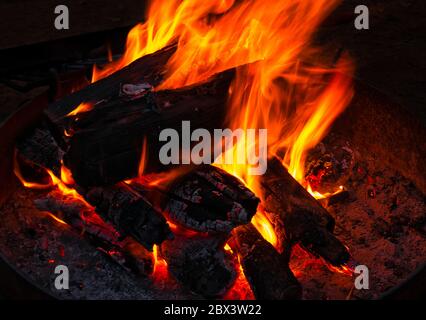 Ein offenes Lagerfeuer in einer runden eisernen Feuerschale Stockfoto