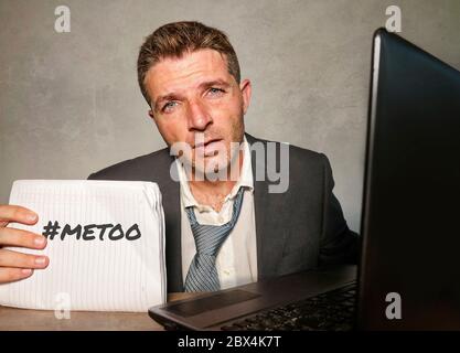 Junge depressive und frustrierte Geschäftsmann verzweifelt im Büro Computer Schreibtisch halten Notizblock mit dem Hashtag mich zu metoo als ausgebeuteten Mitarbeiter victi Stockfoto