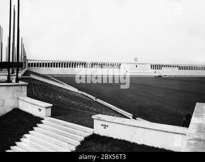 Blick von hinter dem Block 23 auf das Zeppelin-Feld und die von Albert Speer entworfene Haupttribüne auf dem Nürnberger Party-Rallye-Gelände. Oben in der Mitte der Zeppelin-Tribüne ziert ein Hakenkreuz den Ehrenkranz. Stockfoto