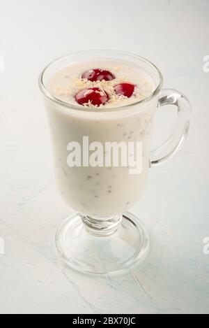 Chia Joghurt Pudding mit Kokosflocken und Kirschenbeeren. Gesunde Ernährung, um Kraft und Gewicht zu reduzieren. Chia und Joghurtpudding im Glas Stockfoto