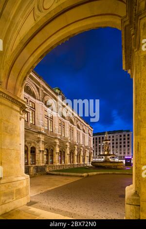 Blick durch einen Bogen der Wiener Staatsoper bei Nacht in Österreich. Stockfoto