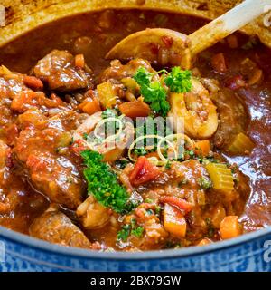 Osso buco alla Milanese in schwerem Topftopf, garniert mit Gremolata. Köstliche traditionelle italienische Kalbsbretter. Stockfoto