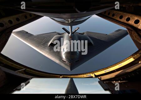 Ein strategischer Bomber der US Air Force B-2 Spirit mit dem 509th Bomb Wing, der sich während einer Betankungsmission am 11. Juni 2014 über dem Nordatlantik unter dem Treibstoffschnorchel eines KC-135 Stratotankers positioniert. Stockfoto