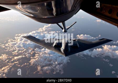 Ein strategischer Bomber der US Air Force B-2 Spirit mit dem 509th Bomb Wing, der sich während einer Betankungsmission am 11. Juni 2014 über dem Nordatlantik unter dem Treibstoffschnorchel eines KC-135 Stratotankers positioniert. Stockfoto