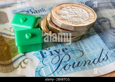 Finanzkonzept. Monopolhäuser und Bargeld, Geld, Darlehen, Hypotheken, Renten-und Schulden. Stockfoto