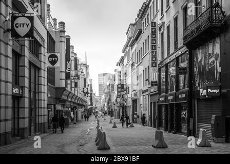 Geschäfte in der Rue Neuve (der Haupteinkaufsstraße) im Zentrum der Stadt Brüssel - Betonbarrieren zur Terrorismusbekämpfung in Brüssel, Belgien Stockfoto