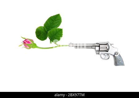 Revolver mit einer roten Rose im Fass auf einem rosa Hintergrund. Stoppen Sie Gewalt und kein Kriegskonzept. Stockfoto