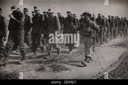 Daumen hoch von einem britischen Soldaten, der einige der Tausenden deutschen Gefangenen nach dem Sieg der Alliierten in El Alamein in Ägypten während der Westwüstenkampagne begleitet. Stockfoto