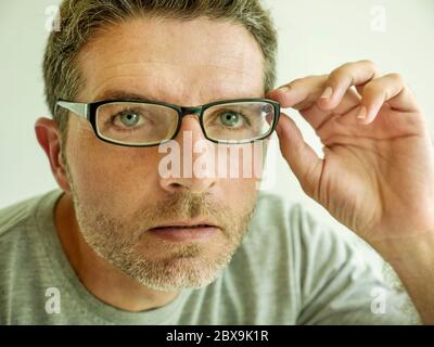 Nahaufnahme Gesicht Porträt von attraktiven Mann Überprüfung Vision versucht Brille bei Optiker. Guy 40s während der optischen Untersuchung Prüfung Brille für cor Stockfoto