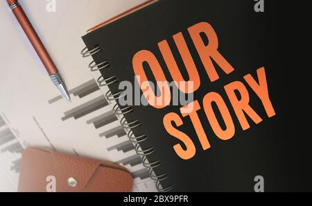Unsere Stroy-Worte auf einem Cover geschrieben, aus Copybook, orange auf schwarz. Business Story Konzept. Selektiver Fokus Stockfoto