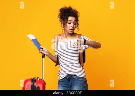 Traveler Girl Check Zeit Stehen Mit Koffer, Studio Shot Stockfoto