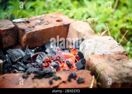 Das Feuer wurde aus Ziegeln auf den Boden gelegt. Picknick Grill Camping in der Natur Stockfoto