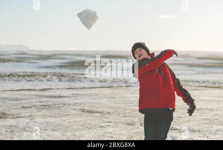 Junge spielt im Schnee, Island Stockfoto