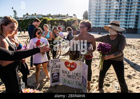 Santa Cruz, Ca. Juni 2020. Blumen werden während einer "Paddel-out" in der Erinnerung an George Floyd am Cowell Beach in Santa Cruz, Kalifornien am 7. Juni 2020 nach dem Tod von George Floyd verteilt. Kredit: Chris Tuite/Image Space/Media Punch/Alamy Live News Stockfoto