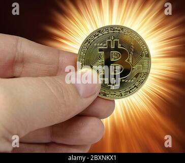Bitcoin Kryptowährung in Mann Hand auf blinkenden Hintergrund Stockfoto
