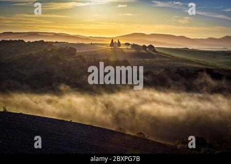 Ein mystischer Herbstaufgang im val d’orcia, mit Blick auf die berühmte Cappella di vitaleta (san quirico d’orcia) Stockfoto