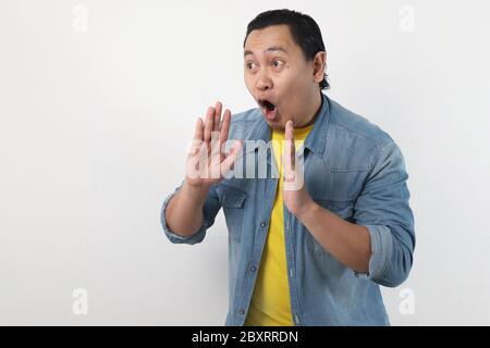 Portrait von lustigen jungen asiatischen Mann schreien und schreien Stockfoto