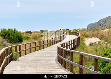 Hölzerne leere Board-Spaziergang durch Sanddünen zum Mittelmeer und Strand von Los Arenales del Sol oder Arenals del Sol. Costa Blanca, Spanien Stockfoto